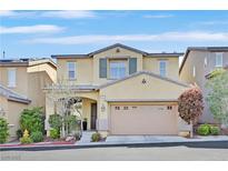 Inviting two-story home boasts a neutral color, well-maintained landscaping, and an attached two-car garage at 10449 Yew Blossom Ave, Las Vegas, NV 89166