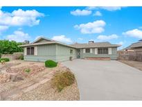 Charming single-story home featuring desert landscaping and a spacious driveway at 2058 Citroen St, Las Vegas, NV 89142