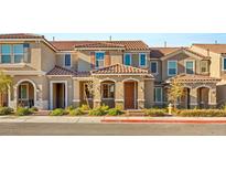 Charming townhome featuring a tiled roof, neutral stucco, and well-maintained landscaping in a cozy neighborhood at 2409 Bellinzona Pl, Henderson, NV 89044