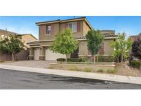 Charming two-story home with stone accents, a well-manicured lawn and three-car garage at 2583 Hazelburn Ave, Henderson, NV 89044