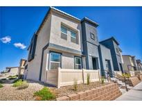 Two-story home featuring a contemporary design, neutral colors, and a beautifully landscaped front yard under a clear blue sky at 3725 Celesta Vista Ave, Henderson, NV 89044