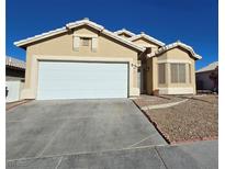 Inviting single-story home featuring a wide two-car garage and desert landscaping at 3836 Quail Creek Dr, North Las Vegas, NV 89032