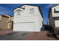 Two-story home featuring a two-car garage, neutral paint, and low maintenance landscaping at 3916 Via Lucia Dr, Las Vegas, NV 89115