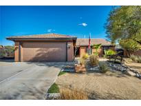 Charming single-story home with a two-car garage, desert landscaping, and an inviting front entrance at 430 Wickenburg St, Henderson, NV 89015