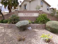 Welcoming community sign 'Tripoly at King's Hill' set amidst lush landscaping and decorative rock at 4330 Westbury Square St # 3, North Las Vegas, NV 89032