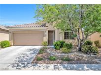 Charming single-story home with well-manicured landscaping, a two-car garage, and a cozy front porch at 5218 Blue Gum Ct, Las Vegas, NV 89148