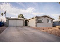 Single-story home featuring an attached garage and desert landscaping at 5408 Longridge Ave, Las Vegas, NV 89146