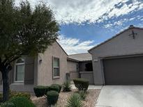 Charming single-story home featuring a well-maintained front yard with a desert landscape at 5525 Criollo Dr, Las Vegas, NV 89122