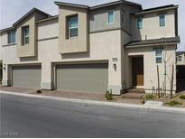 Modern two-story townhome featuring a two-car garage and stylish architectural details at 5642 Sunset Amber Ave, Las Vegas, NV 89122