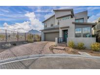 Contemporary two-story home with desert landscaping, brick driveway, and mountain views at 705 Carlon Hills Ave, Las Vegas, NV 89138