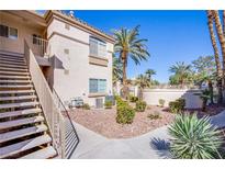 Well-maintained two-story exterior with landscaped grounds and staircase access at 7400 W Flamingo Rd # 1087, Las Vegas, NV 89147