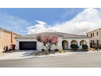 Beautiful home featuring a tiled roof, arched entry, desert landscaping, and a spacious two-car garage in a desirable neighborhood at 9359 Brownstone Ledge Ave, Las Vegas, NV 89149