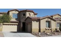 Charming two-story home with a two-car garage, beautiful stonework, and desert landscaping at 9394 Vital Crest St, Las Vegas, NV 89123