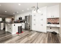 Bright kitchen features stainless steel appliances, granite countertops, and white cabinets at 10091 Sand Key St, Las Vegas, NV 89178