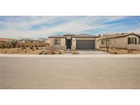 Charming single-story home with a two-car garage and low maintenance desert landscaping at 127 Crimson Cactus Ave, Henderson, NV 89011