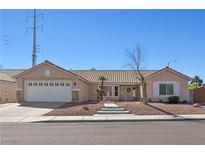 Charming single-story home with a well-maintained front yard and two-car garage in a friendly neighborhood at 1405 Bugle Boy Dr, Henderson, NV 89014