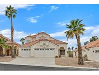 Charming two-story home with desert landscaping, a red tile roof, and a three-car garage at 15 Richland Acres Ct, Henderson, NV 89074