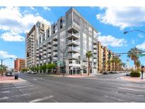Contemporary building with large windows and balconies in a vibrant urban setting at 353 E Bonneville Ave # 311, Las Vegas, NV 89101
