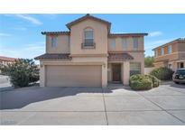 Two-story home featuring a neutral color scheme, an attached two car garage, and concrete driveway and sidewalks at 5963 W Dewey Dr, Las Vegas, NV 89118