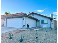 Charming single-story home with a two-car garage and desert landscaping at 7728 Barbican Ct, Las Vegas, NV 89147