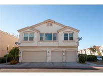 Three car garage exterior view of condo, each with its own entrance and front window at 8628 Tomnitz Ave # 101, Las Vegas, NV 89178
