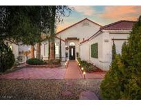 Charming single-story home featuring manicured landscaping and a warm, inviting entrance at 1312 Frost Flower Dr, North Las Vegas, NV 89032