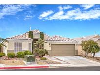 Charming single-story home featuring a two-car garage, well-maintained landscaping, and a classic tile roof at 2501 Foxmoore Ct, Henderson, NV 89052