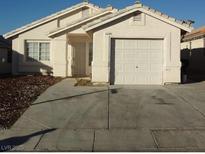 Charming single-story home with a well-maintained front yard and a one-car attached garage at 6608 Elk Creek Ln, Las Vegas, NV 89156