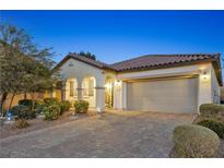 Charming single-story home featuring a paver driveway, two-car garage, and well-manicured landscaping at 7148 Stanley Frederick St, Las Vegas, NV 89166