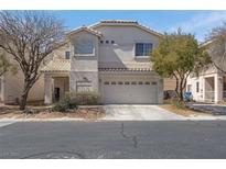 Charming two-story house with a two-car garage and low-maintenance landscaping in a residential neighborhood at 9349 Lakefront Color St, Las Vegas, NV 89178