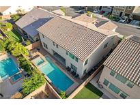 An elevated shot showcasing a backyard oasis featuring a pool, spa, and outdoor seating area at 1004 Bluebird Ridge Ct, North Las Vegas, NV 89084