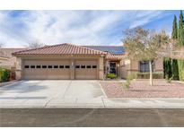Inviting single-story home boasting a red-tiled roof, low-maintenance landscaping, and a spacious three-car garage at 1202 Healing Waters Ln, North Las Vegas, NV 89031