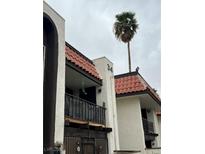 Charming multi-story home featuring a red tile roof and a beautiful palm tree adding to its curb appeal at 1405 Vegas Valley Dr # 344, Las Vegas, NV 89169