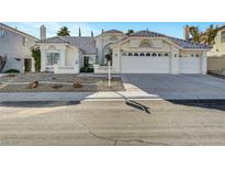 Charming single-story home featuring a three-car garage, desert landscaping, and a classic tile roof at 2221 Loggerhead Rd, Las Vegas, NV 89117