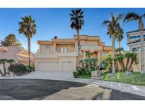 Stunning two-story home boasting lush landscaping and a spacious three-car garage in a luxury community at 2705 Crystal Beach Dr, Las Vegas, NV 89128