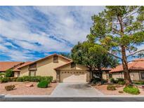 Charming single-story home featuring desert landscaping, a tile roof, and an attached two-car garage at 3975 Saddlewood Ct, Las Vegas, NV 89121