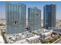 Three striking modern high-rise buildings against a blue sky, showcasing unique architectural design and urban living at 4575 Dean Martin Dr # 1811, Las Vegas, NV 89103