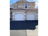 Two-story home with an attached two-car garage, and a red tile roof at 5855 Valley Dr # 2108, North Las Vegas, NV 89031
