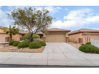 Single story home boasts desert landscaping, mature trees, and a two car garage at 6138 Equine Ave, Las Vegas, NV 89122