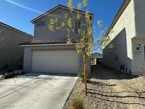 Two story home featuring a two car garage and a side yard at 6843 Toros St, North Las Vegas, NV 89086