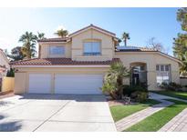 Charming two-story home boasts a three-car garage, tile roof, and well-manicured landscaping at 8324 Slate Harbor Cir, Las Vegas, NV 89128