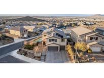 Beautiful two-story home featuring a pool, solar panels, a two car garage and landscaped yard at 864 Firestone Ledge Ave, Henderson, NV 89012