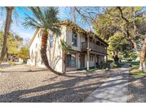 Charming two-story home featuring a balcony, desert landscaping and a sidewalk leading to the front door at 3141 Pinehurst Dr # C, Las Vegas, NV 89109