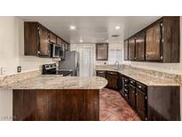 Traditional style kitchen with dark cabinets and granite countertops at 3436 Miramar Dr, Las Vegas, NV 89108