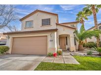 Charming two-story home with a two car garage, desert landscaping and beautiful palm trees at 3728 Russell Peterson Ct, Las Vegas, NV 89129