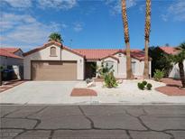 Charming single-story home with a red tile roof, desert landscaping and a two-car garage at 4303 Totano Dr, North Las Vegas, NV 89032