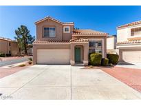 Inviting two-story home with a terra cotta tiled roof and a well-manicured lawn at 8860 Hampton Green Ave, Las Vegas, NV 89129