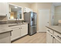Bright kitchen features stainless steel appliances, light wood floors, and white cabinets at 9000 S Las Vegas Blvd # 1187, Las Vegas, NV 89123