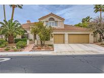 Charming two-story home featuring a tile roof, landscaped front yard, and an attached two-car garage at 138 Wentworth Dr, Henderson, NV 89074