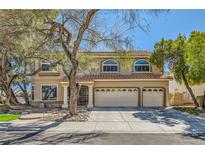 Charming two-story home with well-manicured landscaping, mature trees, and a three-car garage on a sunny day at 20 High Sierra Dr, Henderson, NV 89074
